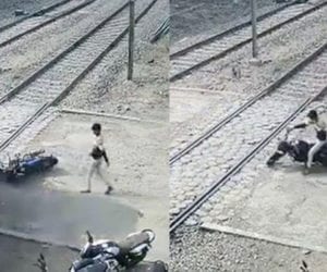 Indian youth nearly escapes being run over by train