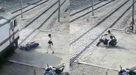 Indian youth nearly escapes being run over by train