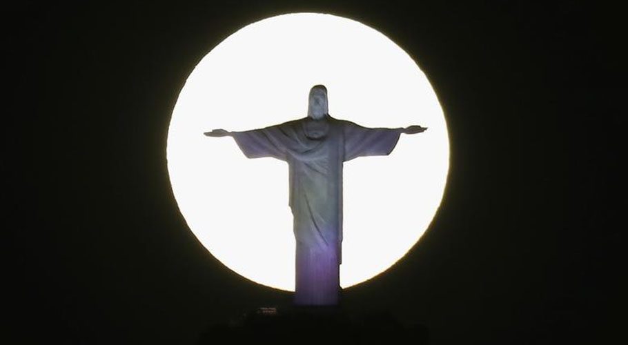 The super moon shines behind the Christ the Redeemer statue in Rio de Janeiro, Brazil. Source: Reuters 