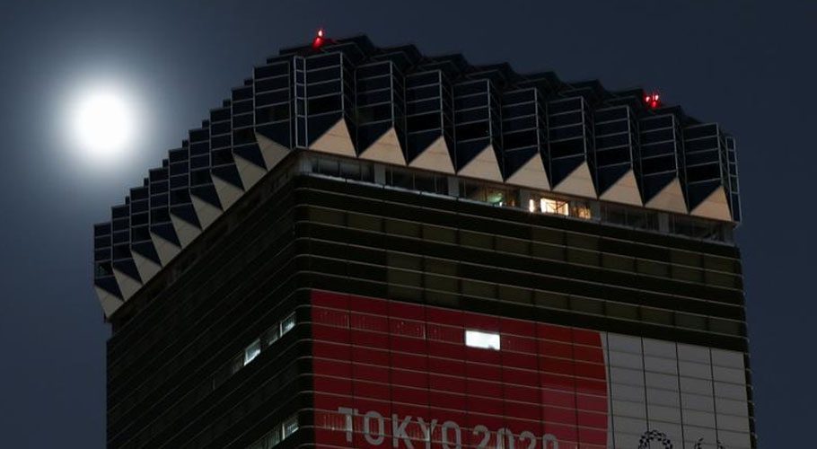 A supermoon, the biggest and brightest full moon of the year, shines next to a building displaying a a banner of the Tokyo 2020 Olympic Games, in Tokyo, Japan. Source: Reuters 