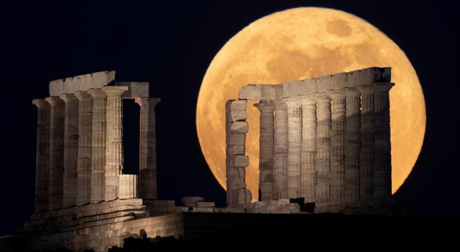 The full moon, known as the "Super Flower Moon" rises over the Temple of Poseidon in Cape Sounion, near Athens, Greece. Source: Reuters 