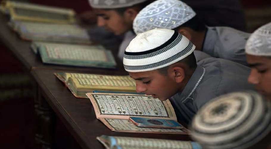 Pakistani students at a madrassa recite the Quran.