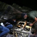 People inspect the damage at the site where a fire broke out at a coronavirus hospital. Source: Reuters.