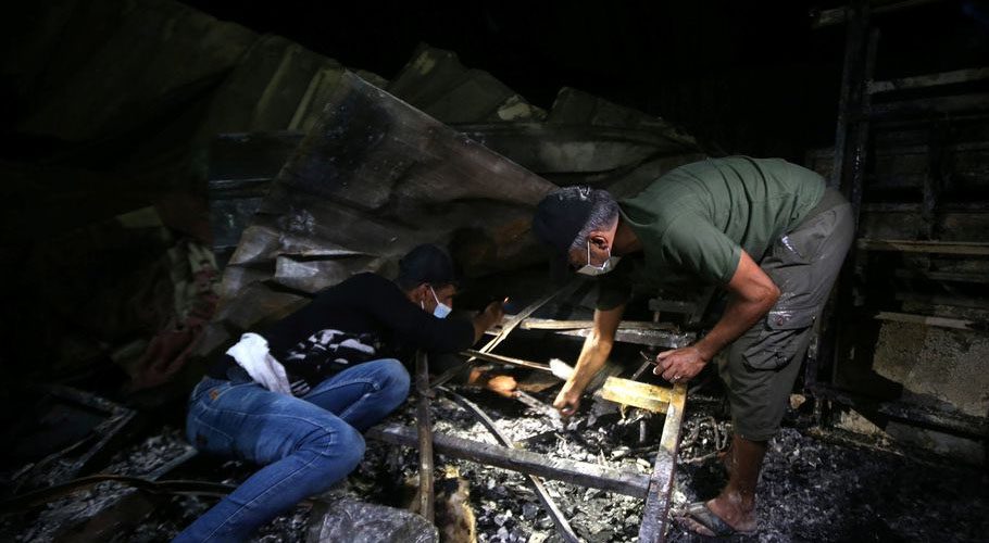 People inspect the damage at the site where a fire broke out at a coronavirus hospital. Source: Reuters.