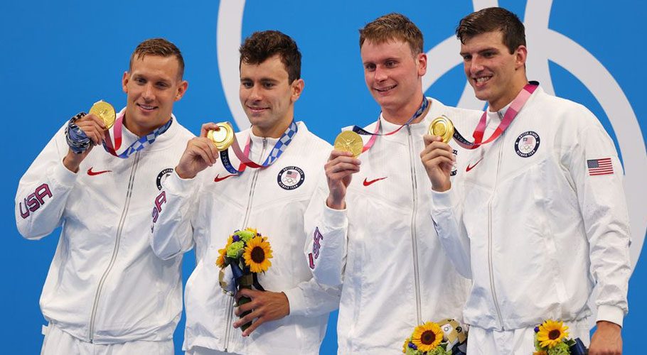 The swimming freestyle relay team poses with their gold medals. Source: Reuters