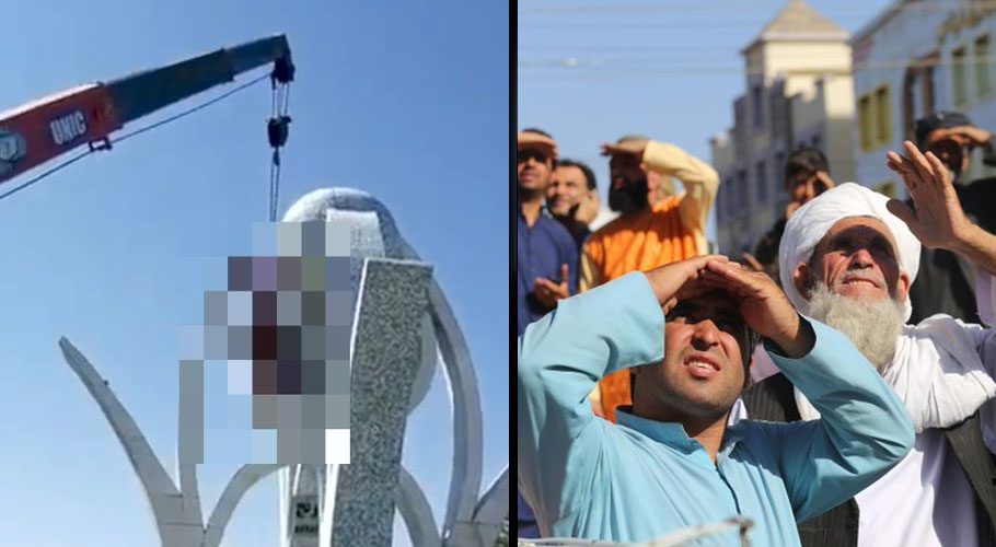 People look up at a dead body hanged by the Taliban from a crane in the main square of Herat city. Source: Twitter/AP.