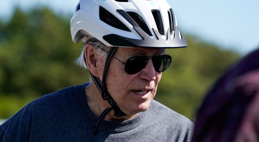 US President Joe Biden rides a bike in Rehoboth Beach, Delaware