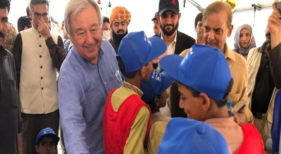 Pakistan's PM Shehbaz Sharif (2R) and UN Secretary-General Antonio Guterres (2L) meet with internally displaced flood-affected children at a makeshift camp during their visit to Usta Mohammad city in Jaffarabad district, Balochistan. (AFP)