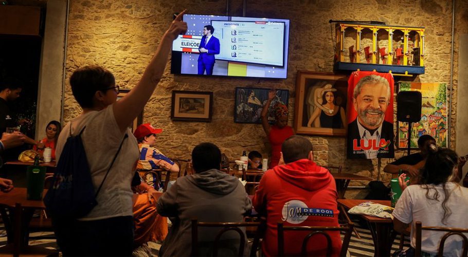 People gather at a bar to watch early results of the presidential election, in Rio de Janeiro, Brazil October 2, 2022. REUTERS/Pilar Olivares