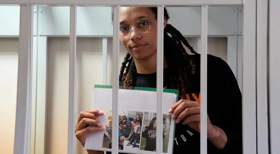 WNBA star and two-time Olympic gold medalist Brittney Griner holds images while standing in a cage in a courtroom in Khimki, Russia, outside Moscow, on July 27. Credit: Alexander Zemlianichenko/Pool via REUTER