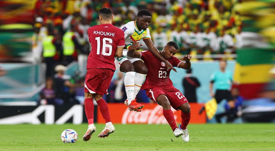 FIFA World Cup Qatar 2022 - Group A - Qatar v Senegal - Al Thumama Stadium, Doha, Qatar - November 25, 2022 Qatar's Assim Madibo and Boualem Khoukhi in action with Senegal's Bamba Dieng REUTERS/Bernadett Szabo