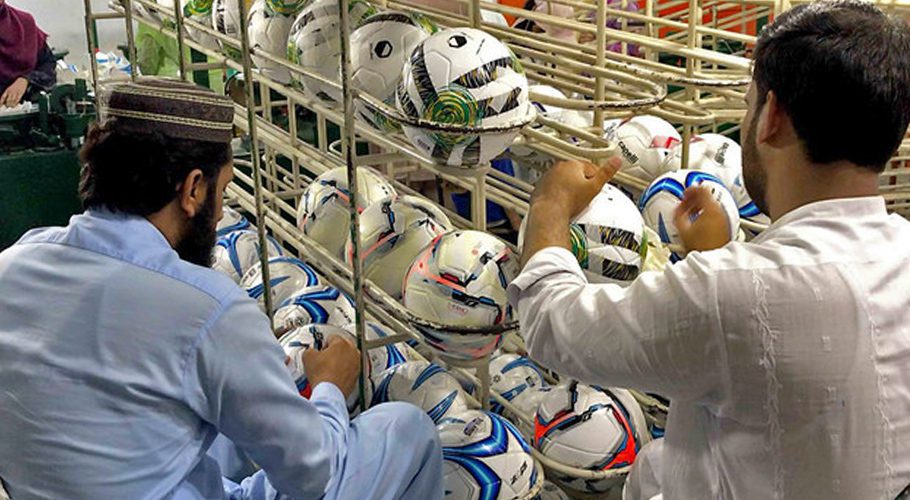 Factory workers make footballs in a factory in Sialkot, Pakistan, on June 20, 2022. (Photo courtesy: Urdu News)