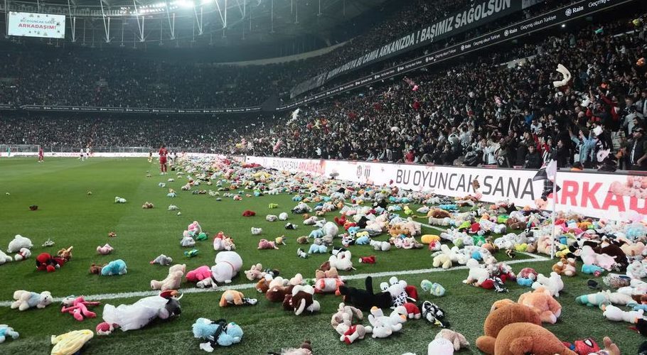 Fans throw toys on the pitch for children affected by earthquake during a Turkish Super League match between Besiktas and Antalyaspor at Vodafone Park in Istanbul, Turkey February 26, 2023. REUTERS/Stringer