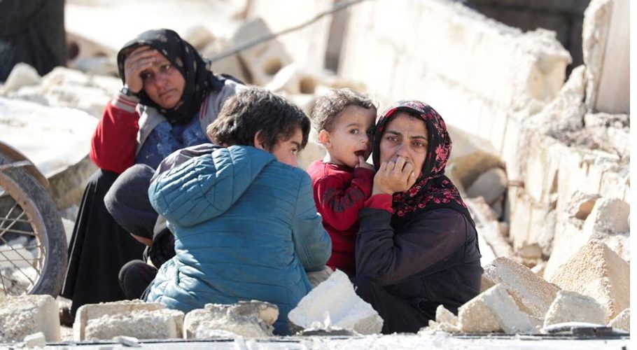 People sitting on the rubble react in the aftermath of an earthquake, in rebel-held town of Jandaris, Syria February 7, 2023. REUTERS/Khalil Ashawi