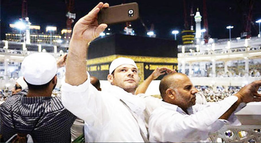 Visitors take pictures at the Grand Mosque in Makkah. (File photo)