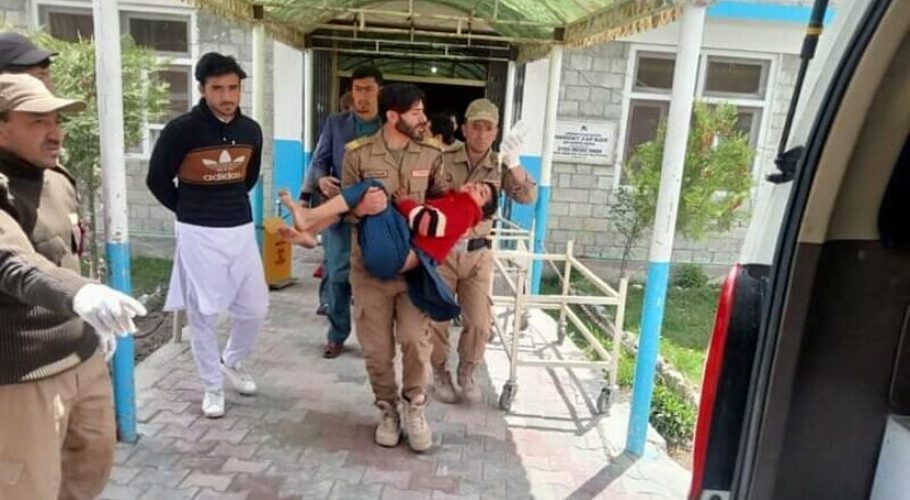 Officials carry a child injured in a road accident in Gilgit-Baltistan on Saturday. — (Image: Dawn.Com)