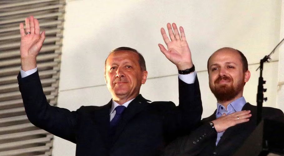 Turkish Prime Minister Tayyip Erdogan (L), accompanied by his son Bilal, greets his supporters at the AK Party headquarters in Ankara March 30, 2014. REUTERS/Stringer/File Photo