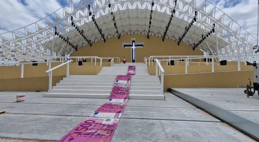 An artwork installation titled "Walk of Shame" depicting carpet with oversized 500 euros banknotes on, is seen rolled at a main stage of the World Youth Day, as a sign of protest over Portugal's state expenditure on Pope Francis' visit, by Portuguese artist Bordalo II, in Lisbon, Portugal July 28, 2023. BORDALO II/Handout via REUTERS THIS IMAGE HAS BEEN SUPPLIED BY A THIRD PARTY