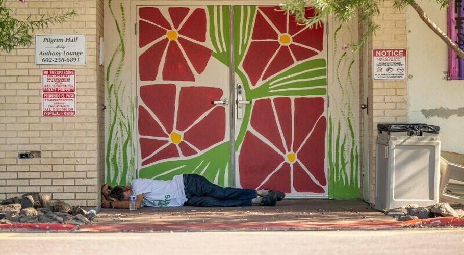 A person sleeps outside in the shade on July 13, 2023 in Phoenix, Arizona. — AFP