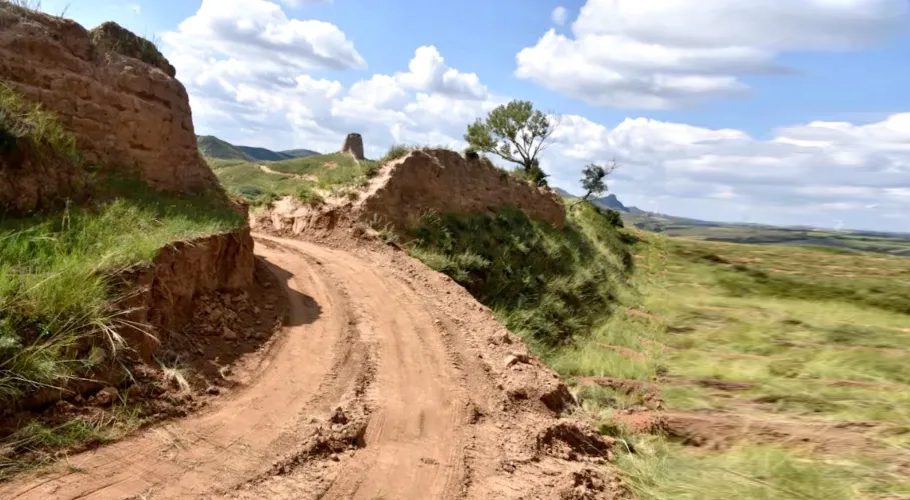 The dirt road created through the damaged section of the wall [Youyu County Public Security Bureau/Handout via Reuters]