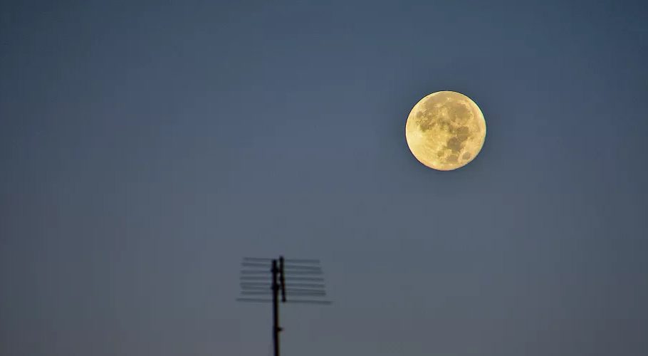 The Full Harvest Moon is seen behind the silhouette of a television antenna in Marseille, France on Sept. 11, 2022. (Image credit: SOPA/Getty Images)