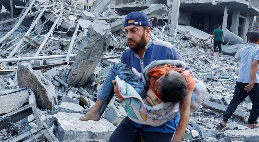 Palestinians carry a casualty following Israeli strikes on houses in Rafah in the southern Gaza Strip, October 17. REUTERS/Ibraheem Abu Mustafa