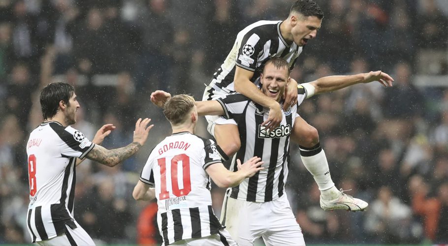 Newcastle's Dan Burn, bottom right, celebrates with teammates after scoring his side's second goalduring the Champions League group F soccer match between Newcastle and Paris Saint Germain at St. James' Park, Wednesday, Oct. 4, 2023, in Newcastle, England. (AP Photo/Scott Heppell)Scott Heppell