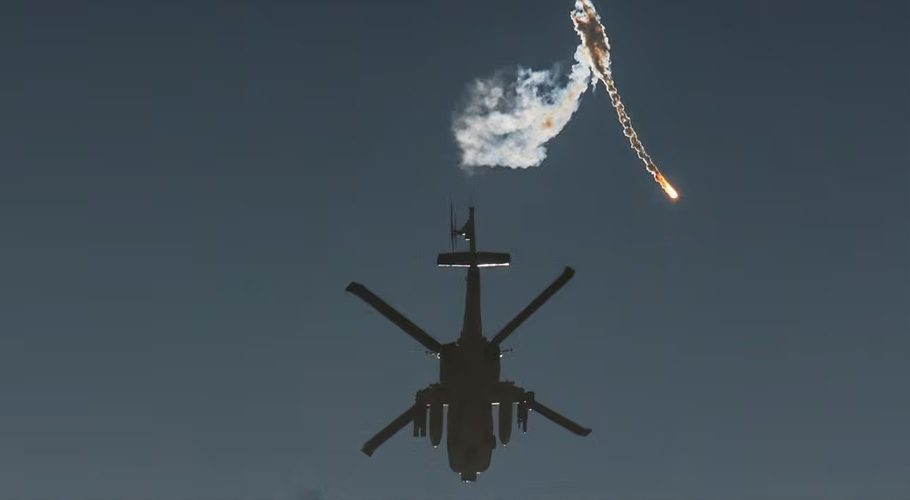 An Israeli military helicopter releases a flare over the Israel-Gaza border, after a temporary truce between Israel and the Palestinian Islamist group Hamas expired, as seen from southern Israel, December 1, 2023. REUTERS/Amir Cohen Acquire Licensing Rights