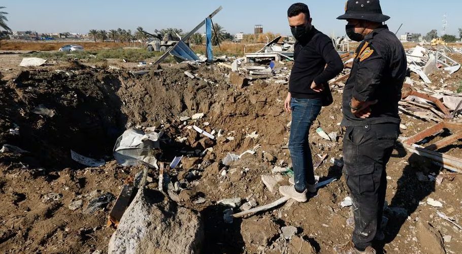 A fighter of the Iraqi Kataib Hezbollah militia group and a man inspect the site of a U.S. airstrike, in Hilla, Iraq December 26, 2023. REUTERS/Alaa al-Marjani Acquire Licensing Rights