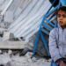 FILE Palestinian child sits at the site of an Israeli strike on a house, amid the ongoing conflict between Israel and the Palestinian Islamist group Hamas, in Rafah in the southern Gaza Strip, February 7, 2024. REUTERS/Ibraheem Abu Mustafa/File Photo
