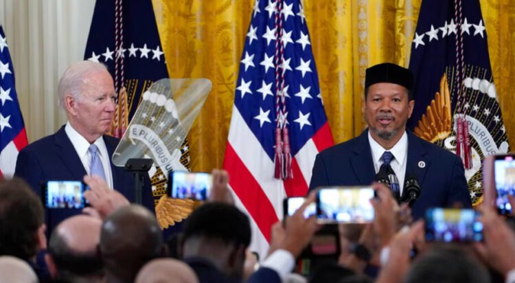 FILE/AP - President Joe Biden, left, listens as Talib M. Shareef, President and Imam of Masjid Muhammad in Washington, speaks during a reception to celebrate Eid al-Fitr, in the East Room of the White House in Washington, May 2, 2022.