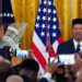 FILE/AP - President Joe Biden, left, listens as Talib M. Shareef, President and Imam of Masjid Muhammad in Washington, speaks during a reception to celebrate Eid al-Fitr, in the East Room of the White House in Washington, May 2, 2022.