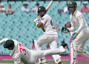 Pakistan’s Aamir Jamal (C) plays a shot as Australia’s David Warner (L) follows the ball during day four of the third cricket Test match between Australia and Pakistan at the Sydney Cricket Ground in Sydney on January 6, 2024. (AFP/File)