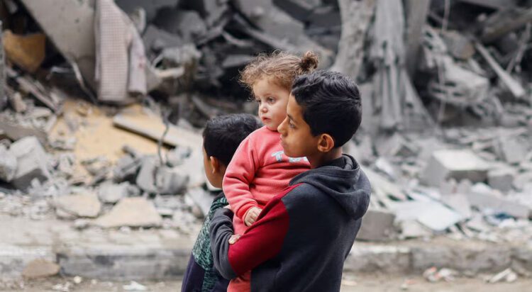 Palestinian children react near the site of an Israeli strike on a house, amid the ongoing conflict between Israel and the Palestinian Islamist group Hamas, in Rafah, in the southern Gaza Strip, March 24, 2024. REUTERS/Mohammed Salem