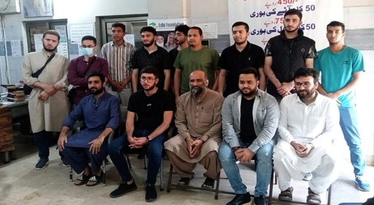 Faisal Edhi (c), the head of the iconic Edhi Foundation in Pakistan, gestures for a group photo with Palestinian students from Gaza, who are currently enrolled in various local educational institutions, in Karachi on March 30, 2024. (Photo courtesy: Edhi Foundation)