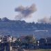 A picture taken from from the southern Lebanese village of Tayr Harfa, near the border with Israel, shows smoke billowing near an Israeli outpost from rockets fired by Hezbollah on Dec. 15. 
AFP via Getty Images
