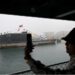 This picture taken during a media tour organised by the Chinese People's Liberation Army Navy (PLAN) to mark its 75th founding anniversary, shows a woman taking pictures of a submarine at the PLA Naval Museum in Qingdao, China's Shandong province on April 23, 2024. (AFP/File)