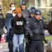 Northeastern University Police remove and arrest protesters one by one at the tent encampment on campus in Boston on Saturday, April 27, 2024. (John Tlumacki/The Boston Globe via AP)