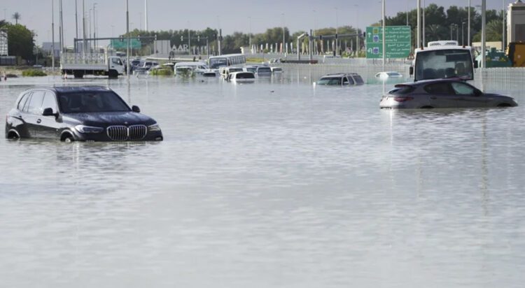 Vehicles sit abandoned in floodwater covering a major road in Dubai, United Arab Emirates, April 17, 2024. (AP Photo/Jon Gambrell)