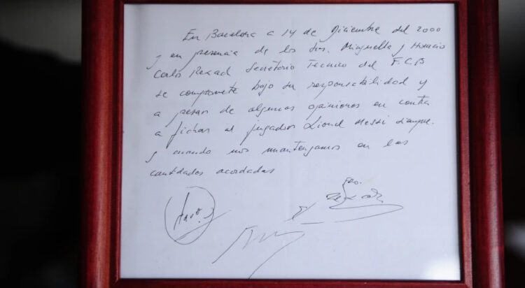 FILE - A framed copy of the napkin linking the 13-year-old Lionel Messi to FC Barcelona is seen in Barcelona, Spain on Jan. 5, 2012. British auction house Bonhams says the famous napkin that linked a young Lionel Messi to Barcelona has sold for $965,000. An agreement in principle to sign then 13-year-old Messi was written on the napkin almost 25 years ago at a Barcelona tennis club. (AP Photo/Manu Fernandez, File)