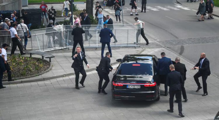 Security officers move Slovak PM Robert Fico in a car after a shooting incident, after a Slovak government meeting in Handlova, Slovakia, May 15, 2024. REUTERS/Radovan Stoklasa