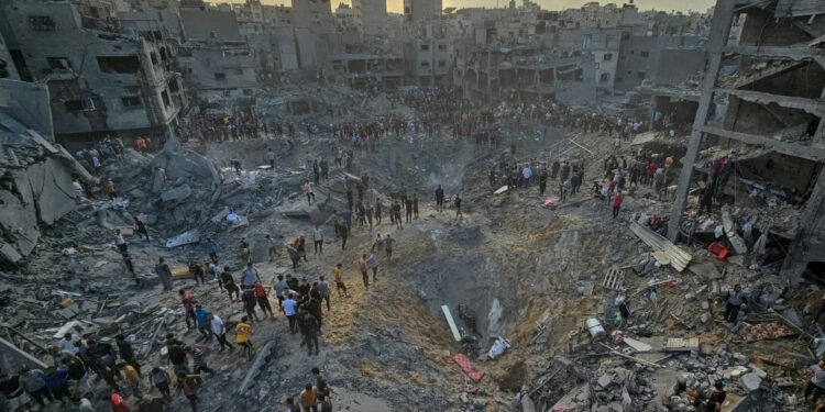 Palestinians search for casualties at the site of Israeli strikes on houses in the Jabalia refugee camp in the northern Gaza Strip on October 31, 2023. According to the Government Media Office in Gaza, more than 313,000 residential units have been destroyed or damaged in Gaza by Israeli bombing. [Anas al-Shareef/Reuters]
