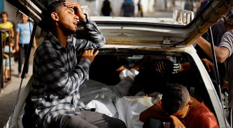 Mourners react next to the bodies of Palestinians killed in an Israeli strike on an area designated for displaced people, during their funeral in Rafah, in the southern Gaza Strip, May 27. REUTERS/Mohammed Salem
