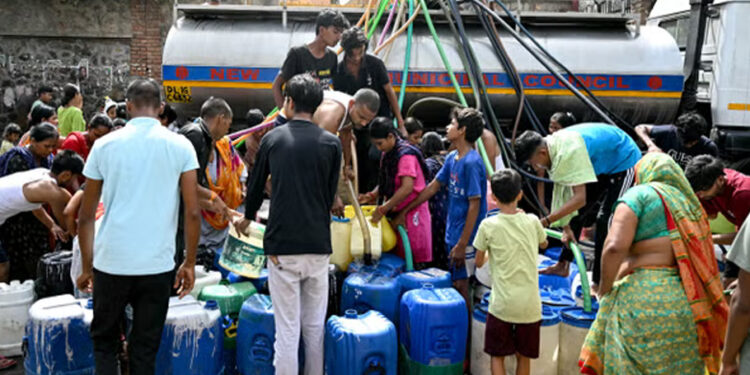 Residents fill their containers with water supplied by a municipal tanker in Delhi, India (AFP via Getty)
