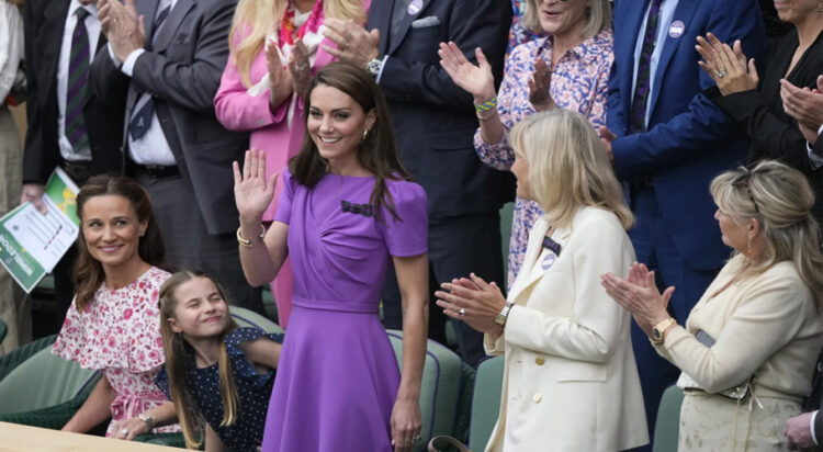 Kate, Princess of Wales waves to the crowd from the Royal Box, with her daughter Princess Charlotte, and her sister Pippa Matthews, left, looks on ahead of the men's singles final at the Wimbledon tennis championships in London, Sunday, July 14, 2024. (AP Photo/Mosa'ab Elshamy)ASSOCIATED PRESS