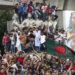 Protesters climb a public monument as they celebrate the news of Prime Minister Sheikh Hasina’s resignation, in Dhaka, Bangladesh, Monday, Aug. 5, 2024. (AP Photo/Rajib Dhar)
