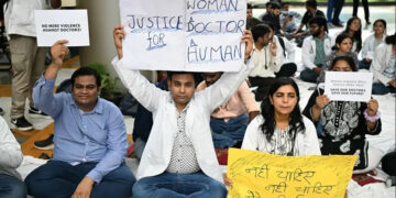 Practicing doctors and medical staff display placards as they take part in a protest against the incident of rape and murder of a young medic in Kolkata, during a demonstration held at a government hospital in New Delhi on August 12, 2024. (AFP)