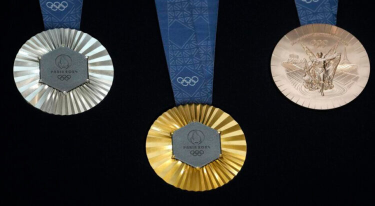 The Paris 2024 Olympic medals are pictured at the Paris Olympic organizers in Saint-Denis, outside Paris, Thursday, Feb. 8, 2024. A hexagonal, polished piece of iron taken from the iconic Eiffel Tower landmark is being embedded in each gold, silver and bronze medal that will be hung around athletes' necks at the July 26-Aug. 11 Paris Games and Paralympics that follow. (AP Photo/Thibault Camus)
Thibault Camus