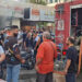 People gather as smoke rises from a mobile shop in Sidon, Lebanon September 18, 2024. REUTERS/Hassan Hankir