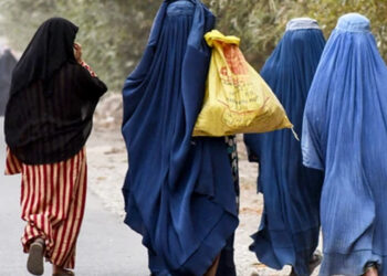 Burqa-clad women walk along a street on the outskirts of Kandahar, Afghanistan, on October 15, 2024. Photo by Sanaullah Seiam/AFP via Getty Images